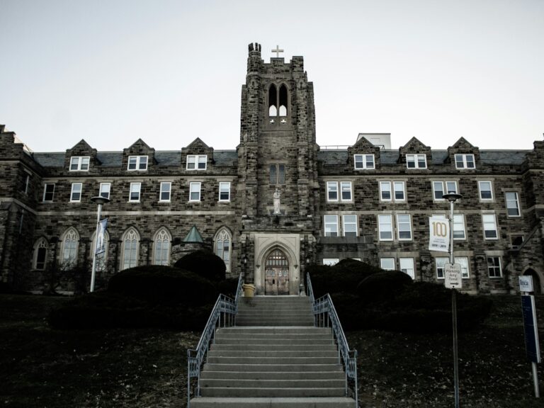 Stone facade of a Gothic-style building with a tower in London, Ontario, Canada.